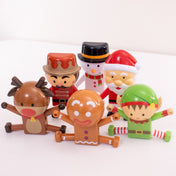 Set of Christmas-themed figurines including a reindeer, gingerbread man, snowman, and elf on a white background.
